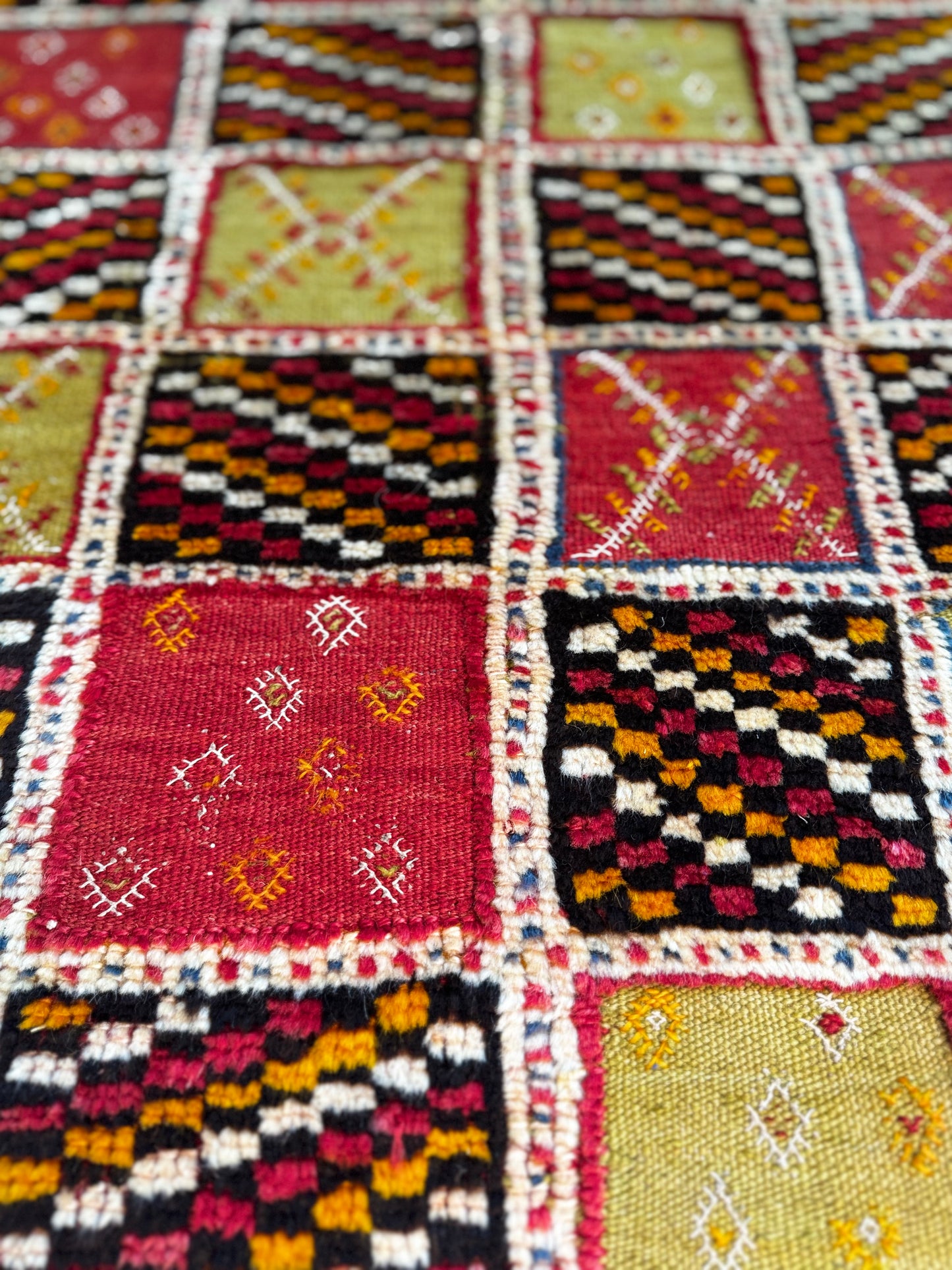 Close-up of Handwoven Colorful Taznakht with geometric patterns.