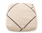 Beige pouf with black geometric lines on a white background