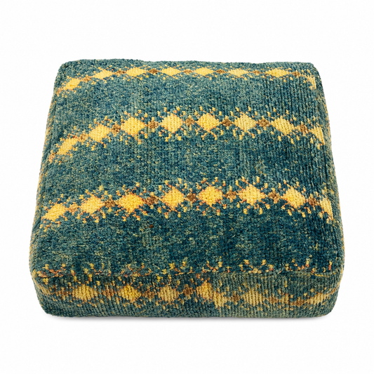 Textured square pillow with blue and yellow pattern on a white background