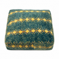 Textured square pillow with blue and yellow pattern on a white background