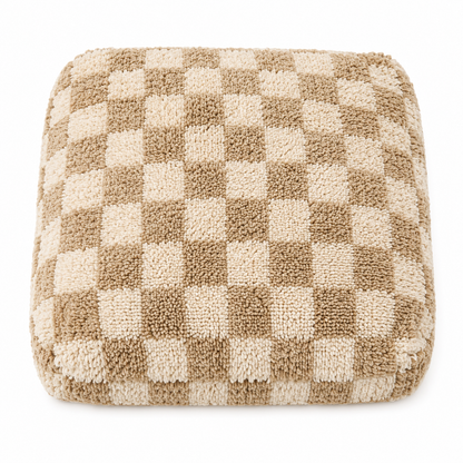 Checkered cushion with brown and beige squares on a white background