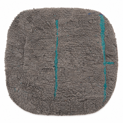 Gray textured mat with teal accents on a white background