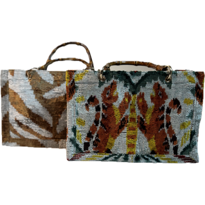 Two woven bags with animal pattern designs on a white background