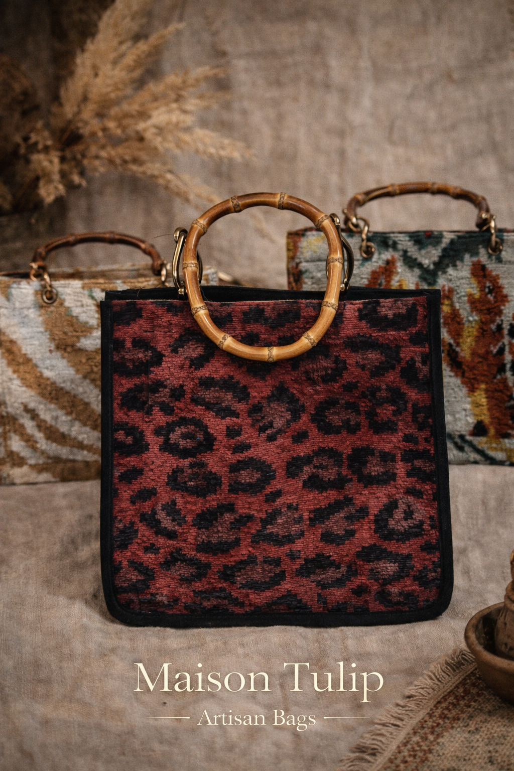 Leopard print handbag with wooden handle on a textured surface, featuring 'Maison Tulip Artisan Bags'.