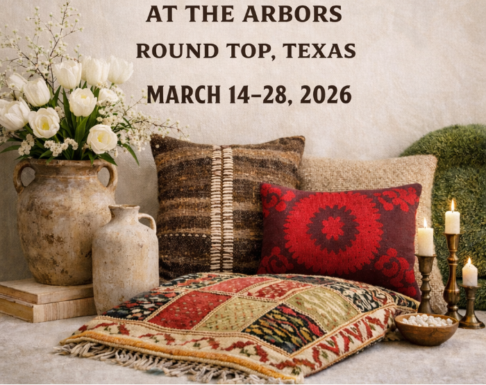 Decorative setting with pillows, flowers, and candles on a textured surface, featuring 'Maison Tulip' event details.