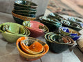 Collection of colorful ceramic bowls on a tiled surface