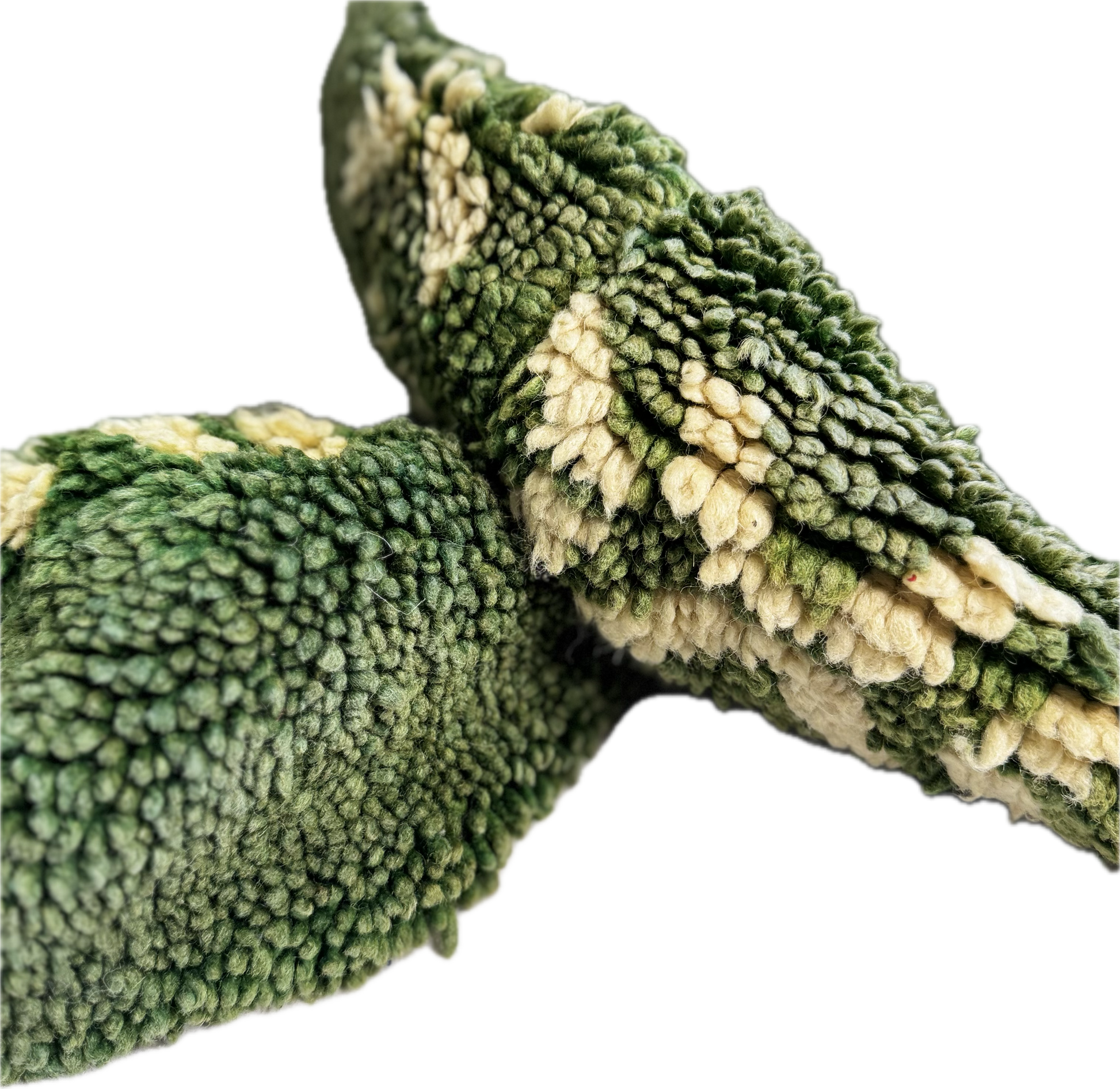 Close up of 100% wool pouf. Green and beige textured fabric on a white background.