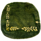 Green textured rug with decorative yellow border on a white background