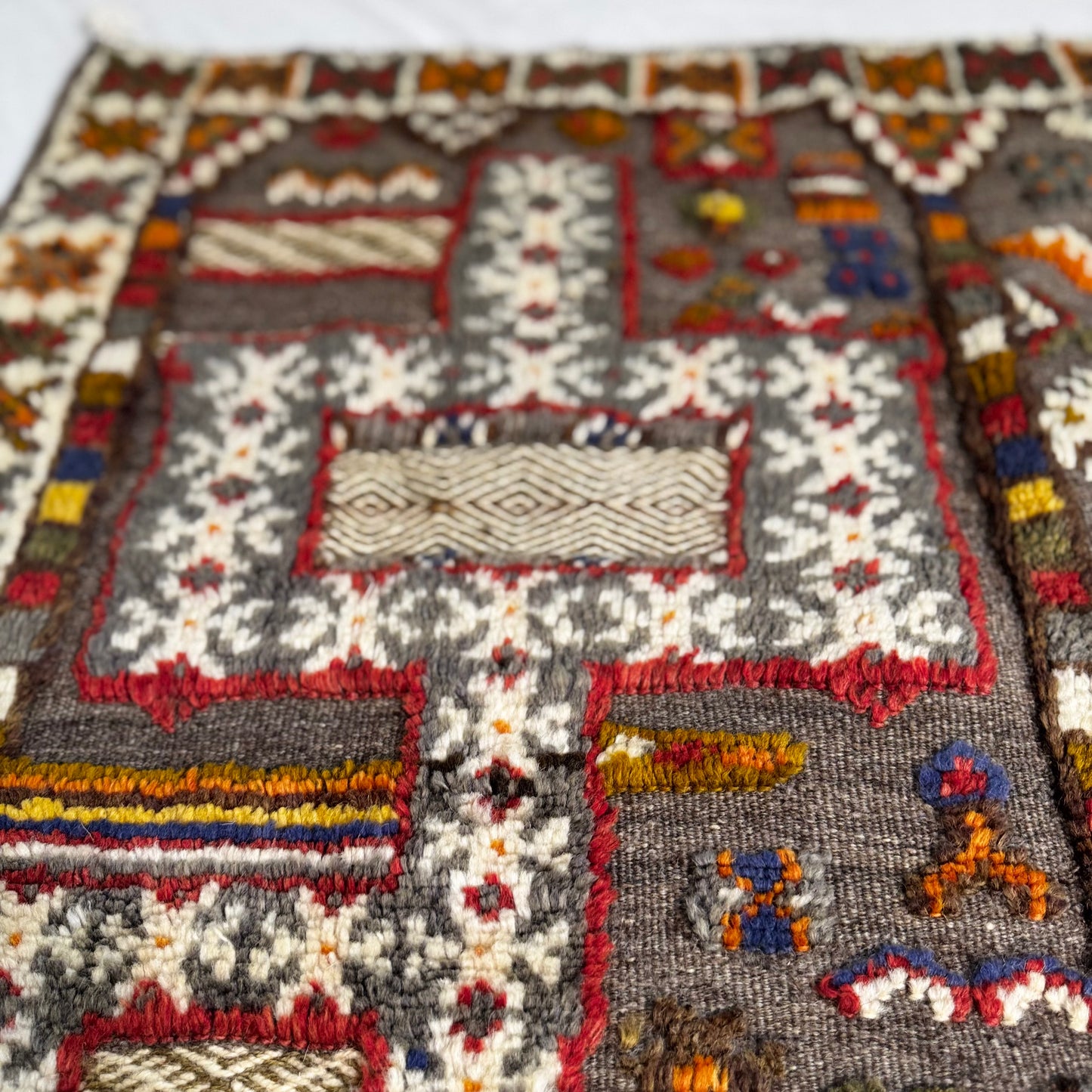Close-up of a patterned kilim with intricate designs.
