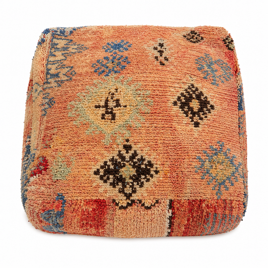 Decorative ottoman with a patterned design on a white background