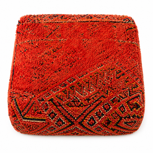 Red textured clutch bag with geometric pattern on a white background