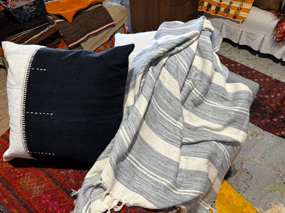 Thick striped blanket on a textured surface