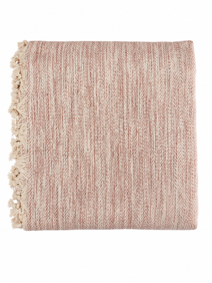 Pink textured blanket with tassels on a white background