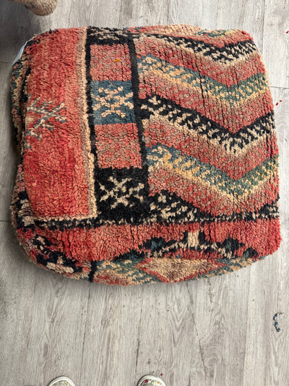 Textured rug with geometric pattern on a wooden floor