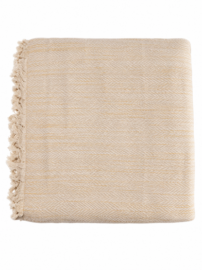 Yellow woven blanket with fringes on a white background